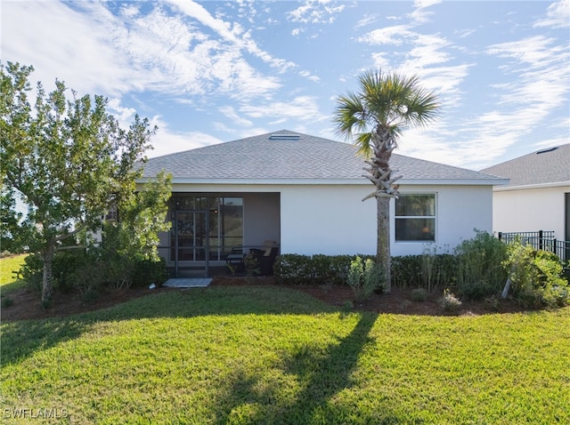 rear view of property featuring a yard