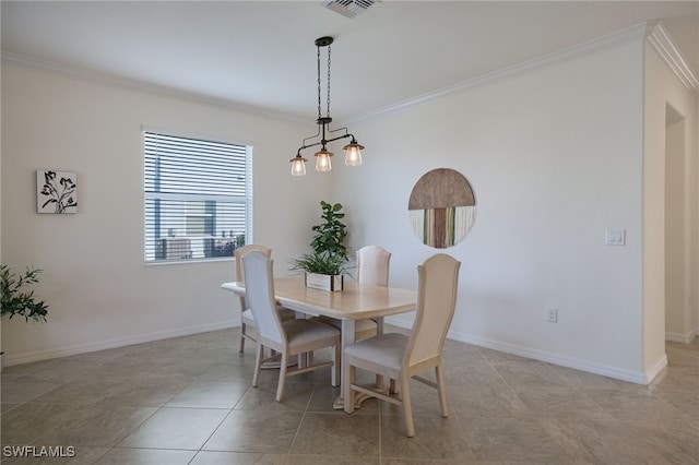 tiled dining space featuring crown molding