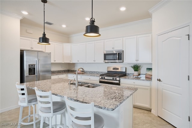 kitchen with sink, hanging light fixtures, an island with sink, stainless steel appliances, and white cabinets