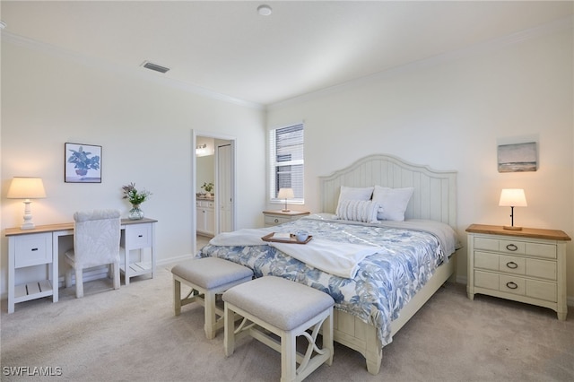 bedroom featuring ensuite bath, ornamental molding, and light colored carpet