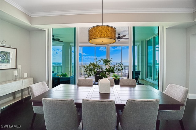 dining space featuring expansive windows, ceiling fan, ornamental molding, and wood-type flooring