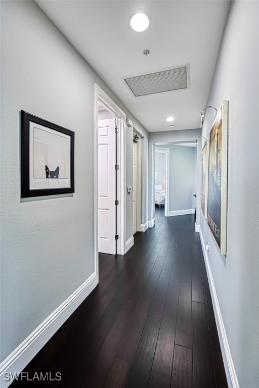 corridor featuring dark hardwood / wood-style floors