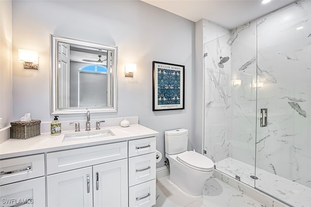 bathroom with a shower with door, vanity, and toilet