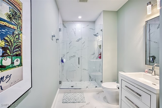 bathroom featuring vanity, a shower with door, and toilet