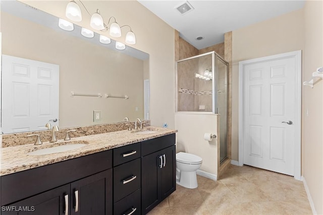 bathroom featuring vanity, tile patterned flooring, toilet, and walk in shower