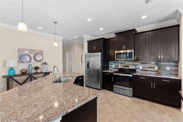 kitchen with sink, appliances with stainless steel finishes, backsplash, hanging light fixtures, and dark brown cabinetry