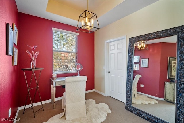 carpeted office with a chandelier and a raised ceiling