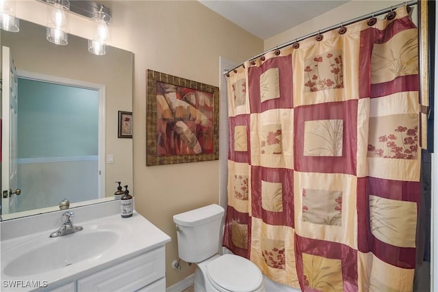 bathroom featuring vanity, curtained shower, and toilet