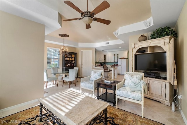 living room with ceiling fan with notable chandelier