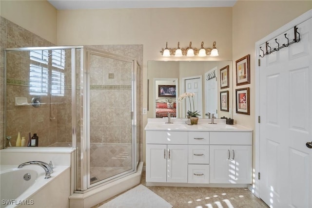 bathroom featuring tile patterned floors, vanity, and separate shower and tub