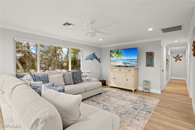 living room with ceiling fan, ornamental molding, and light hardwood / wood-style floors