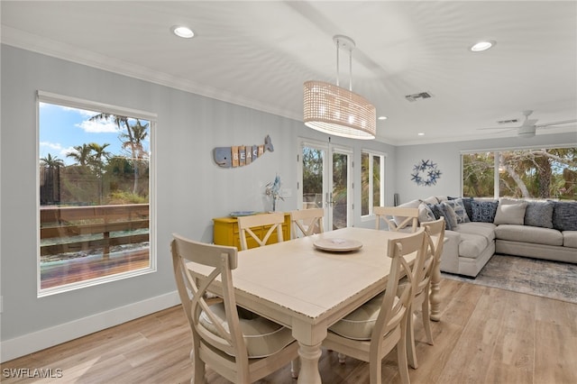 dining room with french doors, ornamental molding, ceiling fan, and light hardwood / wood-style flooring