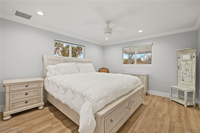 bedroom featuring crown molding, light hardwood / wood-style floors, and ceiling fan