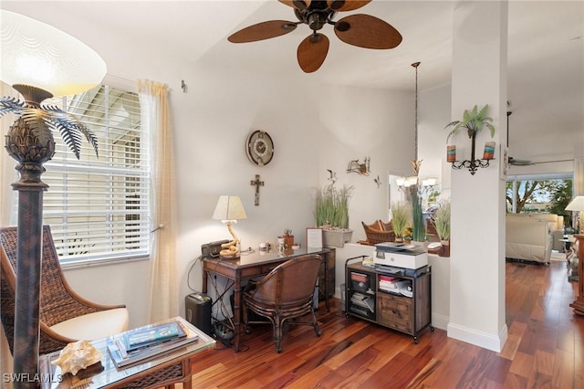 office with dark wood-type flooring, plenty of natural light, and ceiling fan with notable chandelier