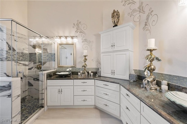 bathroom featuring vanity and an enclosed shower