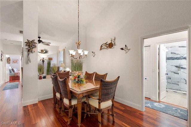 dining area featuring dark wood-type flooring, ceiling fan, and lofted ceiling