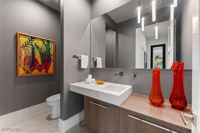 bathroom featuring vanity, backsplash, tile patterned flooring, and toilet