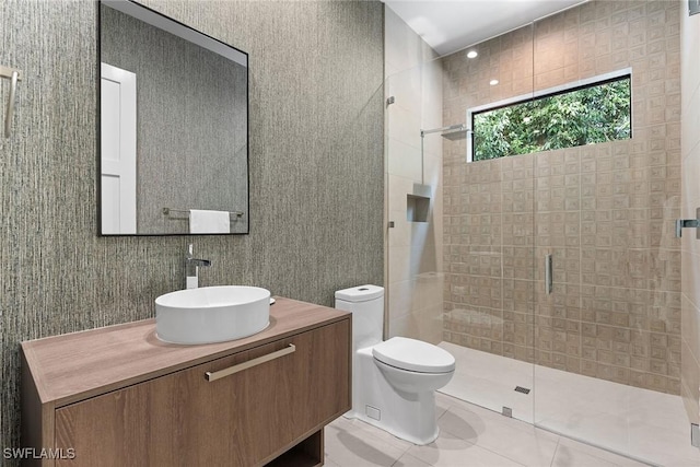 bathroom featuring vanity, a shower with shower door, tile patterned floors, and toilet