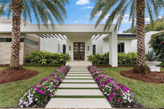 exterior space featuring a front yard and french doors