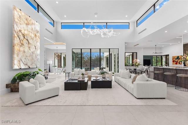 living room with light tile patterned floors and a towering ceiling