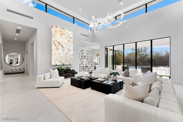 living room with a high ceiling and light tile patterned flooring