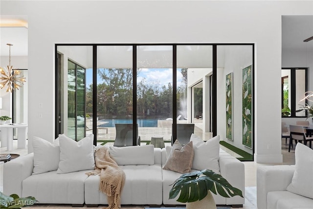 living room featuring a water view and a notable chandelier