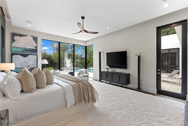 bedroom with multiple windows, access to outside, and ceiling fan