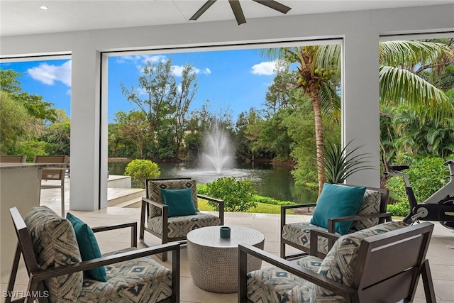 sunroom / solarium featuring a water view