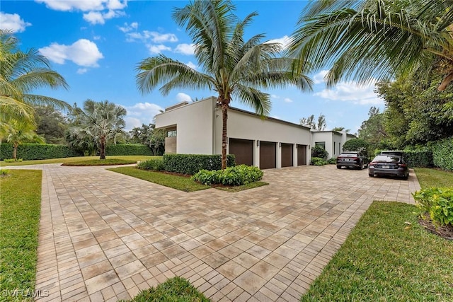 view of side of home featuring a garage and a yard