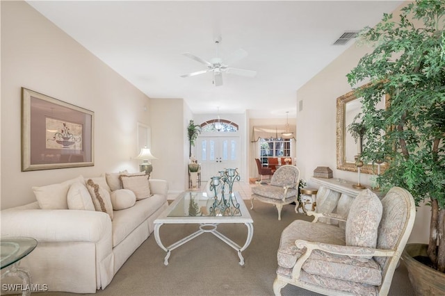 living room with carpet floors, french doors, and ceiling fan