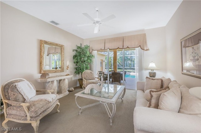 living room with ceiling fan and carpet