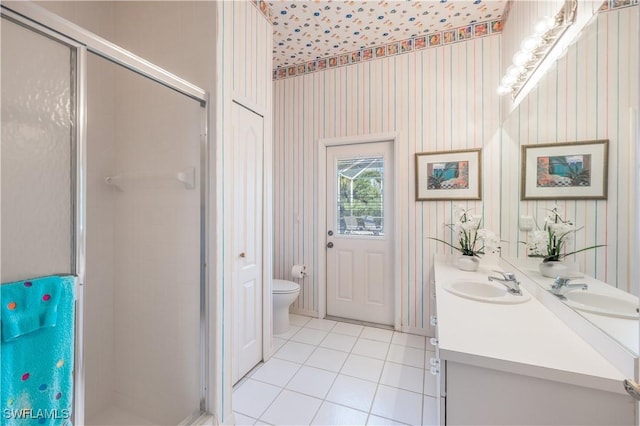 bathroom with vanity, toilet, an enclosed shower, and tile patterned flooring