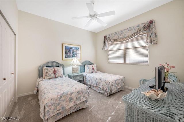 carpeted bedroom featuring ceiling fan and a closet