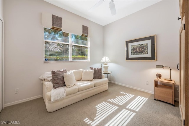 living room featuring light colored carpet and ceiling fan