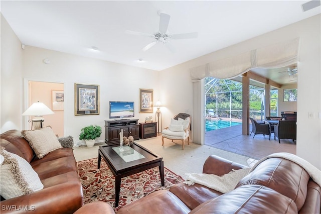 carpeted living room featuring ceiling fan