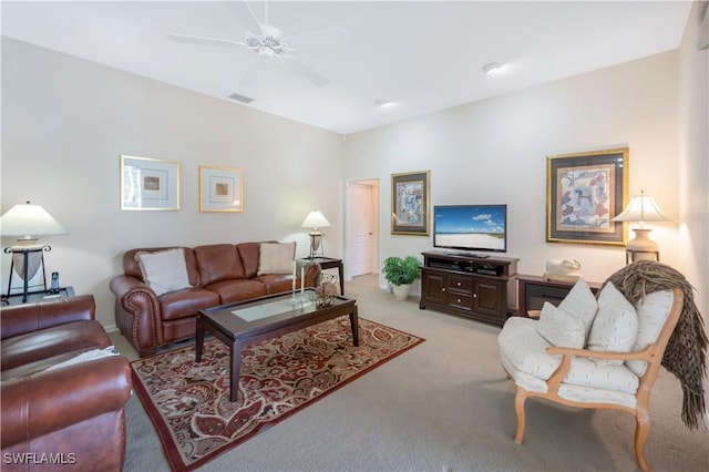 carpeted living room featuring ceiling fan