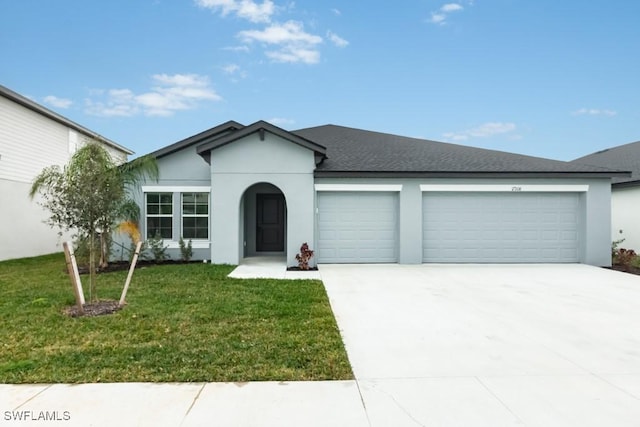 ranch-style house featuring a garage and a front lawn