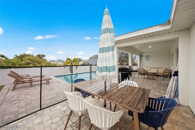 view of patio with an outdoor living space and a fenced in pool