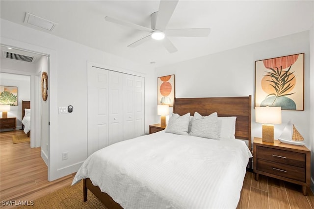 bedroom featuring a closet, ceiling fan, and light wood-type flooring