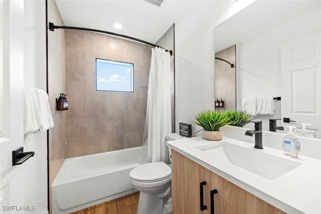 full bathroom with vanity, hardwood / wood-style floors, shower / bath combination with curtain, and toilet