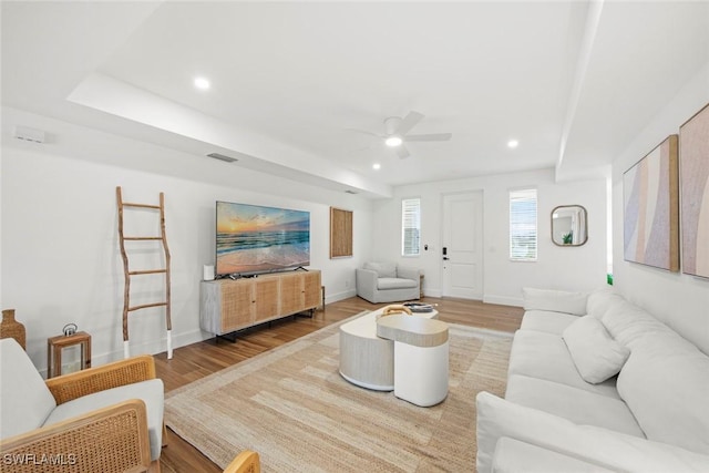 living room with hardwood / wood-style flooring and ceiling fan