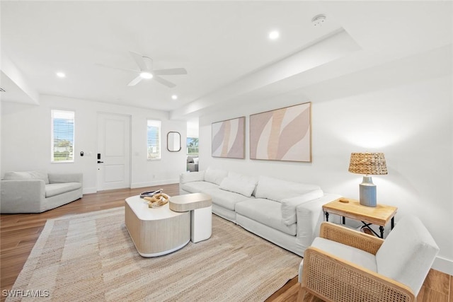 living room featuring ceiling fan and light wood-type flooring