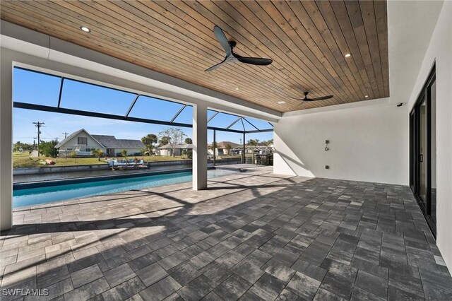 view of swimming pool with a lanai, ceiling fan, and a patio area