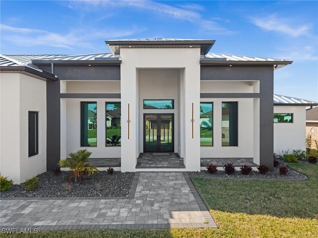 doorway to property featuring a yard