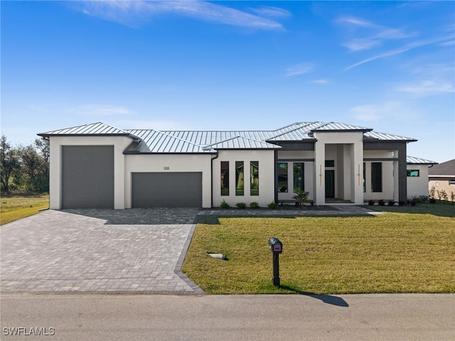 view of front of property featuring a garage and a front yard