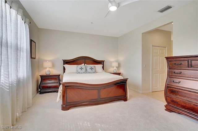 bedroom featuring light carpet and ceiling fan