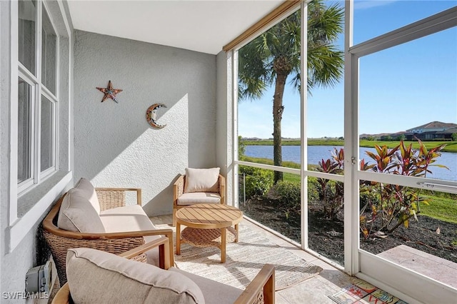 sunroom / solarium with a water view