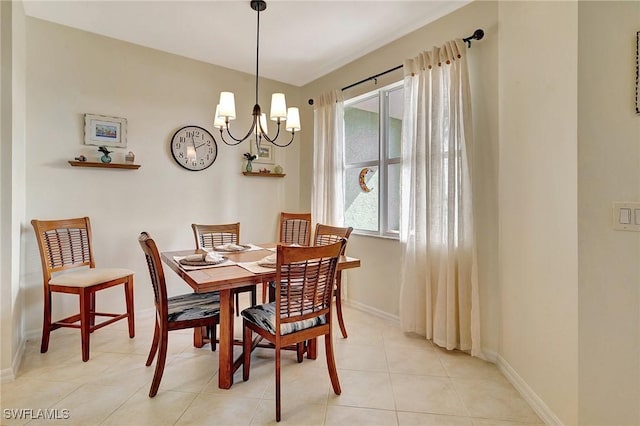 tiled dining room with an inviting chandelier