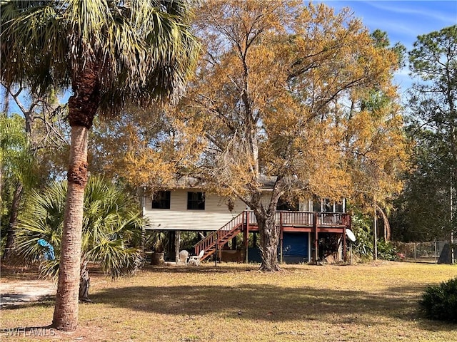 back of house with a wooden deck and a yard