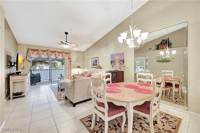 dining space with vaulted ceiling, ceiling fan with notable chandelier, and light tile patterned floors